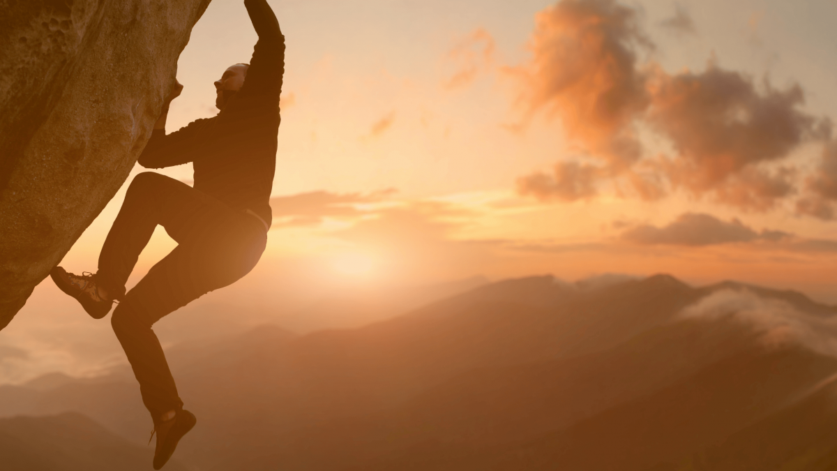 Rock climbing. Male climber trying staying on challenging rock, overcoming obstacles